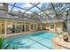 Relaxing screened-in pool area, perfect for outdoor entertaining with lounge furniture and sunny skies at 1689 Wingspan Way, Winter Springs, FL 32708