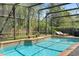 Relaxing screened-in pool featuring a lounge chair and landscaped border at 1689 Wingspan Way, Winter Springs, FL 32708