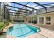 Backyard oasis with screened pool, patio, and lush landscaping at 1689 Wingspan Way, Winter Springs, FL 32708