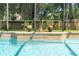 Inviting screened pool with decorative planters and a cascading water feature for backyard enjoyment at 1689 Wingspan Way, Winter Springs, FL 32708