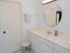 Bathroom featuring a vanity with a round mirror, stool, and a separate door at 1764 Carillon Park Dr, Oviedo, FL 32765