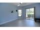 Bedroom with light blue walls, wood-look floors, and access to the screened lanai at 1764 Carillon Park Dr, Oviedo, FL 32765