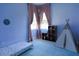 Cozy bedroom with blue walls, two windows, a playful teepee, and carpeted flooring at 1764 Carillon Park Dr, Oviedo, FL 32765