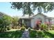 Charming home exterior with lush landscaping, mature trees, and a welcoming front entrance at 1764 Carillon Park Dr, Oviedo, FL 32765