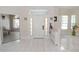 Bright and open foyer featuring tile flooring, a chandelier, and views of adjacent rooms at 1764 Carillon Park Dr, Oviedo, FL 32765