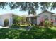 Beautiful one story home with manicured lawn and entryway landscaping at 1764 Carillon Park Dr, Oviedo, FL 32765