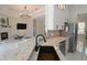 Modern kitchen featuring granite counters, a breakfast bar, and stainless steel appliances at 1764 Carillon Park Dr, Oviedo, FL 32765