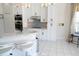 Charming kitchen with white cabinets, granite counters, stainless appliances, and a breakfast bar at 1764 Carillon Park Dr, Oviedo, FL 32765