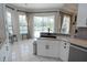 Stylish kitchen with white cabinets, granite counters, a breakfast bar, and a view of the pool at 1764 Carillon Park Dr, Oviedo, FL 32765