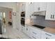 Contemporary kitchen boasting white cabinets, granite counters, and stainless steel appliances at 1764 Carillon Park Dr, Oviedo, FL 32765