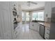 Bright eat-in kitchen showcasing white cabinetry, granite countertops, and stainless steel appliances at 1764 Carillon Park Dr, Oviedo, FL 32765