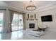 Bright living room with decorative fireplace and sliding door access to pool at 1764 Carillon Park Dr, Oviedo, FL 32765