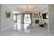 Bright living room with fireplace, tile floors, chandelier and sliding glass doors at 1764 Carillon Park Dr, Oviedo, FL 32765
