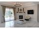 Spacious living room boasts a fireplace, chandelier, and sliding glass doors to the pool area at 1764 Carillon Park Dr, Oviedo, FL 32765