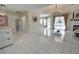 Open living area with tile floors, fireplace, chandelier, and sliding glass doors to the pool area at 1764 Carillon Park Dr, Oviedo, FL 32765