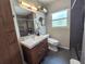 Contemporary bathroom with modern vanity, sleek fixtures, floating shelves, and glass-enclosed shower at 1902 Sarazen Dr, Orlando, FL 32808