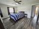 Bedroom with a queen bed, hardwood floors, ceiling fan, and closet at 1902 Sarazen Dr, Orlando, FL 32808