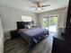 Bedroom with a large bed, hardwood floors, and natural light from sliding glass doors at 1902 Sarazen Dr, Orlando, FL 32808