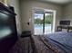 Bedroom view showing window looking out to the backyard pool and landscaping at 1902 Sarazen Dr, Orlando, FL 32808