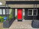 Inviting home exterior featuring a striking red door, black paint, and decorative accents at 1902 Sarazen Dr, Orlando, FL 32808