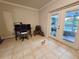 Bright home office with french doors leading to an outdoor pool, desk and chair, and tile flooring at 1902 Sarazen Dr, Orlando, FL 32808
