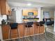Kitchen featuring granite counters, stainless appliances and barstool seating with a view to the living area at 1902 Sarazen Dr, Orlando, FL 32808