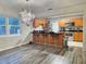 Open concept kitchen with stainless steel appliances, granite counters, and island seating at 1902 Sarazen Dr, Orlando, FL 32808