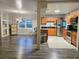 Open-concept living space with a kitchen featuring granite counters, stainless appliances, and an adjacent living area at 1902 Sarazen Dr, Orlando, FL 32808