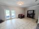 Sitting area featuring tile floors, french doors to the back patio, and a dark bookcase at 1902 Sarazen Dr, Orlando, FL 32808