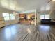 Spacious open floor plan living room with hardwood floors, kitchen, and sofa at 1902 Sarazen Dr, Orlando, FL 32808