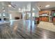 Open floor plan with hardwood floors connecting living room and kitchen, ceiling fan, and brown sofa at 1902 Sarazen Dr, Orlando, FL 32808