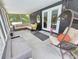 Enclosed patio with comfortable lounge seating, a rocking chair, and a hanging swing at 1902 Sarazen Dr, Orlando, FL 32808