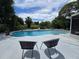 Beautiful backyard swimming pool with seating and lush tropical foliage at 1902 Sarazen Dr, Orlando, FL 32808