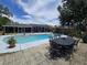 Backyard pool area with an in-ground pool, patio, and outdoor seating at 1902 Sarazen Dr, Orlando, FL 32808