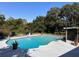 Backyard pool with surrounding lush trees, patio, foliage, and a screened-in area at 1902 Sarazen Dr, Orlando, FL 32808