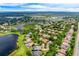 Beautiful aerial view of the community featuring the lake, lush trees, and neighborhood at 2000 Bloomsbury Run, Lake Mary, FL 32746