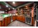 Basement bar with ample storage, granite countertops and stainless steel beverage fridge at 2000 Bloomsbury Run, Lake Mary, FL 32746