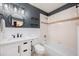 Stylish bathroom featuring vanity, tub with tile surround, and black and white patterned wallpaper at 2000 Bloomsbury Run, Lake Mary, FL 32746
