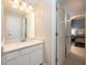 Bright bathroom featuring white cabinets, quartz countertop, a large mirror, and neutral paint color at 2000 Bloomsbury Run, Lake Mary, FL 32746