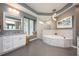 Luxurious bathroom with a soaking tub, marble countertops, and a window seat at 2000 Bloomsbury Run, Lake Mary, FL 32746