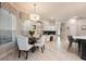 Bright dining area with a modern chandelier, round table, and white upholstered chairs at 2000 Bloomsbury Run, Lake Mary, FL 32746