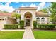 Lovely home featuring an arched entryway, tile roof, and manicured landscaping at 2000 Bloomsbury Run, Lake Mary, FL 32746