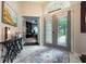 Elegant foyer with stylish rug, decorative table, and a view into the home office at 2000 Bloomsbury Run, Lake Mary, FL 32746