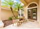 Cozy front porch with seating, landscaping, and a decorative front door at 2000 Bloomsbury Run, Lake Mary, FL 32746