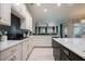 Bright kitchen featuring white cabinets, marble countertops, and an open floor plan at 2000 Bloomsbury Run, Lake Mary, FL 32746