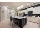 Modern kitchen with an island, stainless appliances, and a mosaic tile backsplash at 2000 Bloomsbury Run, Lake Mary, FL 32746