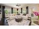 Bright and airy living room featuring a large sectional sofa and views of the backyard at 2000 Bloomsbury Run, Lake Mary, FL 32746