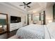 Serene main bedroom with a TV, large windows, and decorative furnishings at 2000 Bloomsbury Run, Lake Mary, FL 32746