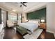 Spacious main bedroom with a green accent wall, tray ceiling, and large windows at 2000 Bloomsbury Run, Lake Mary, FL 32746