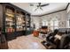 Well-appointed home office with custom bookshelves, a desk, and comfortable seating at 2000 Bloomsbury Run, Lake Mary, FL 32746